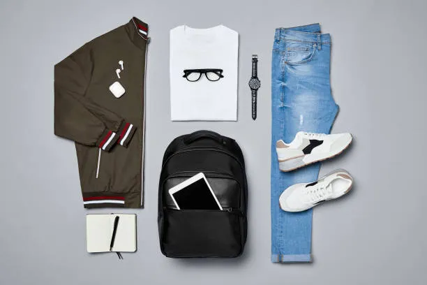 Product image of Fat lay of  travelers clothes and accessories.